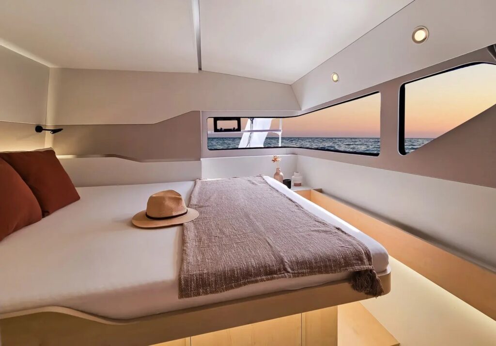 Windelo 54 owner cabin with hull windows at sunset